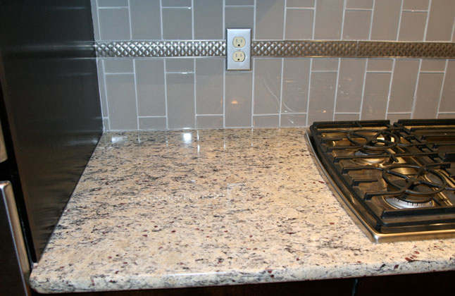 Granite Kitchen Counter with Grey Glass Subway Tile Backsplash