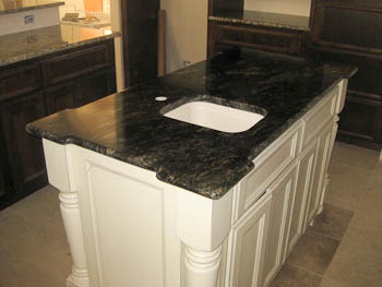 Granite kitchen countertops on white cabinets