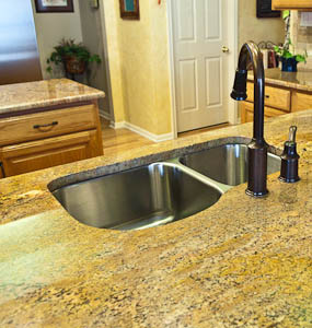 sixty-forty undermount kitchen sink in a granite countertop