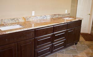 Cherry Master Bathroom Vanity Cabinets with a Granite Countertop